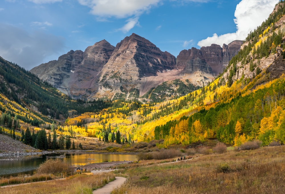 Maroon Bells peaks with peak gold-color leaves surrounding